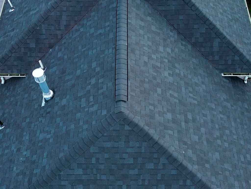 Professional roofing contractor performing a detailed roof inspection on a residential home.